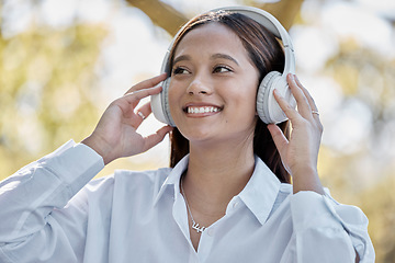 Image showing Music, headphones and business woman in nature streaming podcast or radio. Thinking, smile and happy female entrepreneur listening and enjoying audio album, song and sound track outdoors in park.