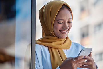 Image showing Phone, city and happy muslim woman on international network, 5g communication and mobile app chat. Young hijab entrepreneur or islamic person from Saudi Arabia typing on cellphone for job opportunity