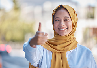 Image showing Thumbs up, smile and portrait of Muslim woman in city for achievement, relax and natural in Indonesia. Islamic, positive and confident with girl wearing hijab in urban town for yes, agreement and joy