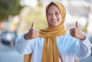 Image showing Thumbs up, happy and portrait of Muslim woman in city for achievement, like and natural in Indonesia. Islamic, positive and confident with girl wearing hijab in urban town for yes, agreement and joy