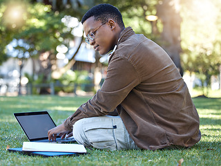 Image showing Black man reading, park and student laptop work in a garden with a education book and lens flare, Outdoor, happiness and elearning with a textbook of a person busy with exam study on university grass