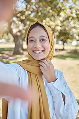 Image showing Muslim, woman in park with hijab and selfie, freedom and travel, nature with peace and calm outdoor. Islamic fashion, youth and gen z with adventure, lifestyle and female in Dubai smile in picture