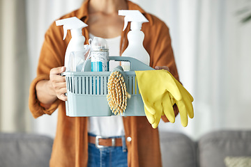 Image showing Hands, housekeeper and woman maid cleaning home with equipment, housework and person for hygiene clean house. Maintenance, service and basket of disinfectant product by worker in living room