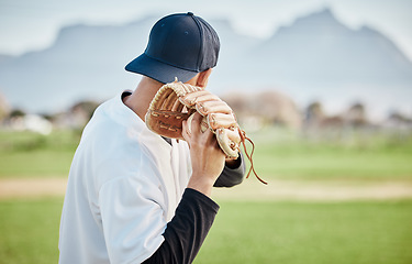 Image showing Pitcher, back view or baseball player training for a sports game on outdoor field stadium. Fitness, young softball athlete or focused man pitching or throwing a ball with glove in workout or exercise