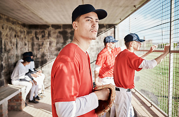 Image showing Baseball, pitcher or dugout with a sports man watching his team play a game outdoor during summer for recreation. Sport, teamwork and waiting with a male athlete on the bench to support his teammates