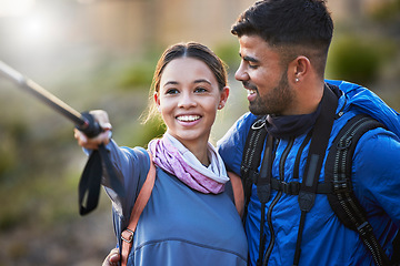 Image showing Couple, hiking selfie and backpack together for smile, happiness and adventure for fitness on mountain. Gen z man, woman and outdoor with stick for social media, profile picture or training with love