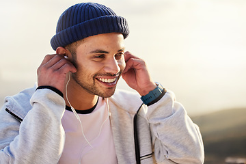 Image showing Man with earphones, listening to music and smile outdoor with runner, fitness and motivation with radio streaming. Podcast, technology and exercise at sunset, happy male and running, audio and sport