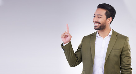 Image showing Mock up, finger and businessman pointing up for branding, product placement and advertising isolated in a studio white background. Latino, professional and man corporate worker is happy for deal