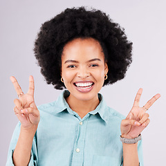 Image showing Happy, peace sign and portrait of black woman in studio for positive, agreement and support. Confidence, smile and emoji with female isolated on gray background for friendly, cheerful and carefree