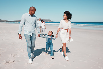 Image showing Love, beach and family holding hands while walking together on a summer vacation, adventure or weekend trip. Happy, activity and parents with their child by the ocean on a tropical holiday in Mexico.