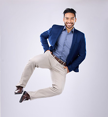 Image showing Happy, freedom and portrait of an Asian man jumping isolated on a white background in a studio. Excited, smile and a Japanese businessman in the air for excitement, energy and ecstatic on a backdrop