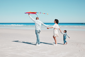 Image showing Holding hands, kite and family walking together at a beach, relax and bonding on ocean background. Flying, toy and couple with daughter at the sea, walk and enjoy a trip in Miami with fun games