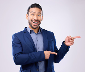 Image showing Happy, portrait and man in a studio pointing to mockup for marketing, advertising or product placement. Happiness, smile and male model from India with showing gesture for mock up by gray background.