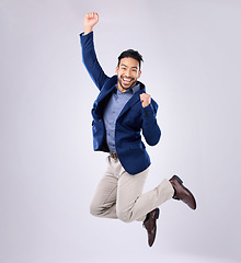 Image showing Success, excited and portrait of an Asian man jumping isolated on a white background in a studio. Happy, winning and Japanese businessman in the air for achievement, celebration and enthusiastic