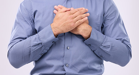 Image showing Closeup, hands on chest and man in studio with self love, hope and love on grey background space. Zoom, hand and open heart gesture by male show emoji, gratitude and calm zen while standing isolated