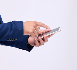 Image showing Man, phone in hands and typing in studio for communication with network connection on social media. Hand of male with smartphone for internet search, mobile app and online chat on a white background