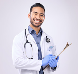 Image showing Portrait, doctor and man with clipboard, healthcare and happiness against grey studio background. Face, male employee and happy medical professional with document, paperwork and report for diagnosis