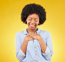 Image showing Black woman, happy and self love with hands on chest for gratitude, peace and calm with eyes closed on yellow studio background. Content, wellness and care with mockup space, happiness and heart