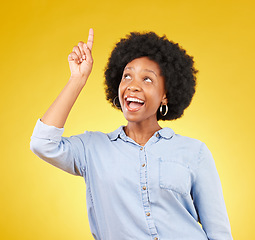 Image showing Studio promotion, happy and black woman point at mock up space, advertising mockup or marketing promo. Commercial girl, gesture and excited person with product placement deal on yellow background