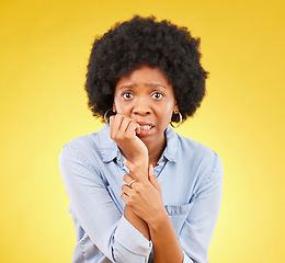 Image showing Fear, anxiety and biting nails with portrait of black woman in studio for scared, worry and nervous. Terror, problem and mental health with female on yellow background for stress, confused and crisis