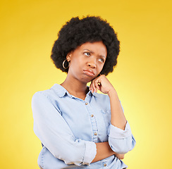 Image showing Black woman, sad face and thinking in studio upset, sulking and disappointed on a yellow background. African female model think of memory, problem or mental health with afro hair and color space