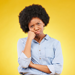 Image showing Black woman, sad face and portrait in studio upset, sulking and disappointed on a yellow background. African female model with fatigue, problem or mental health with afro hair and color space