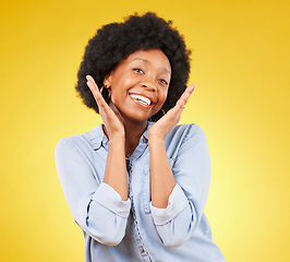 Image showing Black woman, hands on face and smile portrait in studio while excited on yellow background. African female model with afro, beauty and happiness on color space with motivation and positive mindset