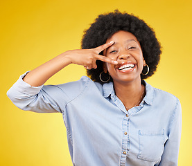 Image showing Black woman, peace sign and smile portrait in studio while happy on yellow background. African female model with hand gesture or emoji while laughing on color with motivation and positive mindset