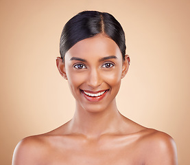 Image showing Portrait, beauty and smile with a model woman in studio on a beige background for natural skincare. Face, happy and aesthetic with an attractive young female posing for cosmetics or luxury wellness