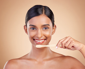 Image showing Portrait, dental and toothbrush with a model woman in studio on a beige background to promote oral hygiene. Face, mouth and dentist up with an attractive young female cleaning or brushing her teeth