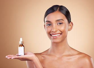 Image showing Portrait, skincare and serum with a model woman in studio on a beige background to promote beauty. Face, product and antiaging with an attractive young female posing for cosmetics or luxury wellness