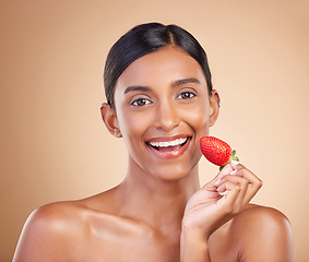 Image showing Portrait, skincare and strawberry with a model woman in studio on a beige background to promote beauty. Face, fruit and nutrition with an attractive female posing for organic or natural cosmetics