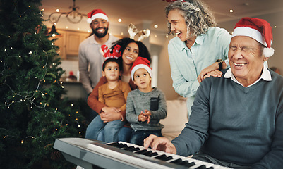 Image showing Christmas, happy family and senior man on piano in living room for celebration, song and bond in their home. Music, instrument and retired pianist performing for kids and parents on festive holiday