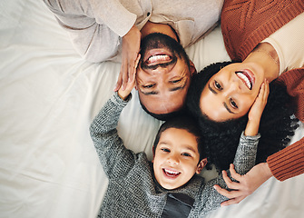 Image showing Top view, love and family in bedroom, smile and quality time for joy, bonding and happiness. Portrait, parents and mother with father, boy and male child on bed, cheerful and relax with affection