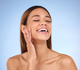 Image showing Skincare, confident and woman beauty with clear and clean skin after a facial isolated in a studio blue background. Soft, natural and self care model due to dermatology due to cosmetic treatment