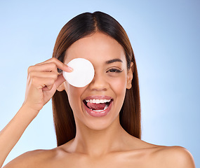 Image showing Beauty, woman and face with cotton pad for skincare dermatology cosmetics in studio. Female model person on a blue background for self care, facial glow and healthy or detox skin with clean results