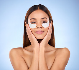 Image showing Beauty, collagen and portrait of woman with eye mask for anti aging skincare glow on blue background. Cosmetics, facial repair and face of hispanic model with wrinkle treatment product in studio.