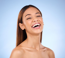 Image showing Skincare, beauty and face of laughing happy woman in studio with smile for skin glow promo on blue background. Makeup, facial and cosmetics, African model for dermatology or spa promotion and mockup.