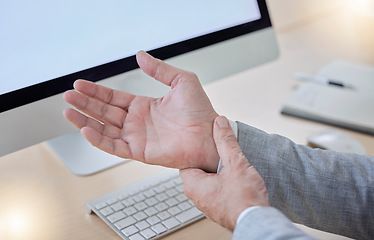 Image showing Hand, arthritis and carpal tunnel with a business man in his office, sitting at a desk suffering from joint pain. Stress, medical or anatomy and a male employee struggling with osteoporosis or injury