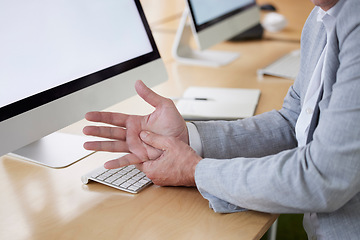 Image showing Hand, carpal tunnel and joint pain with a business man in his office, sitting at a desk suffering from arthritis. Stress, medical or anatomy and a male employee struggling with osteoporosis or injury