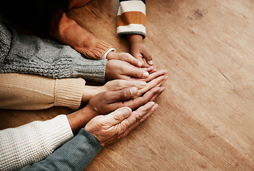 Image showing People, hands together and generations in care above on mockup for unity, compassion or trust on wooden table. Group holding hand for support collaboration, love or community in teamwork solidarity