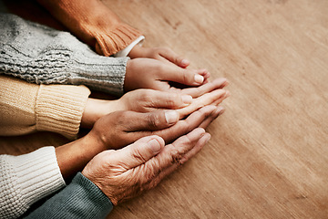 Image showing People, hands together and generations in care above on mockup for unity, compassion or trust on wooden table. Group holding hand in collaboration, love or support for community, teamwork or union