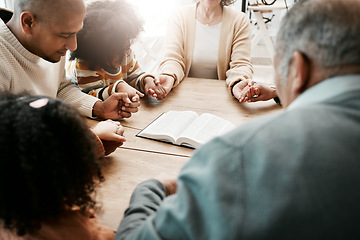 Image showing Holding hands, family and group praying, bible and support with quality time, connect and gratitude. People, believers and community with solidarity, religion and holy book with hope and faith in God