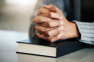 Image showing Bible book, person or hands praying for hope, help or support in Christianity religion or holy faith on table. Believe, prayer or woman studying or worshipping God in spiritual literature at home