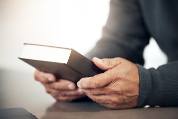 Image showing Book, prayer or bible with hands of man for holy worship, support or hope in Christianity or faith. Believe, religion or zoom of catholic person praying to God in spiritual literature for wellness