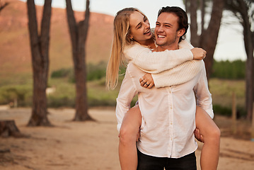 Image showing Laugh, love and sunset with couple and piggyback in nature for romance, affectionate and bonding. Happiness, relax and smile with man carrying woman on date for vacation, cute and sweet relationship