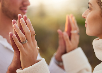 Image showing Love, romance and couple touch hands at sunset for bonding, quality time and romantic weekend. Dating, honeymoon and man and woman with palms together for trust, support and loving for engagement