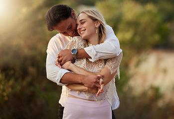 Image showing Couple, love and hug outdoor for care, trust and romance with safety and security. Happy man and woman together on valentines day date with flare, peace and freedom in nature forest holding hands