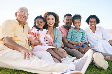 Image showing Family, portrait and generations outdoor, happy people relax on lawn with grandparents, parents and kids. Happiness, smile and sitting together on grass, diversity and love with relationship and bond