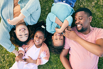 Image showing Top view, black family and parents with kids on grass, carefree and happiness on vacation, relax and smile. Mother, father and children in park, freedom and playful together, love and bonding outdoor